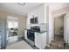 Bright kitchen with stainless steel appliances, black hardware and a view into the living room at 5636 Crittenden Ave, Indianapolis, IN 46220