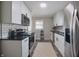 Well-lit kitchen featuring stainless steel appliances, black hardware and tile backsplash at 5636 Crittenden Ave, Indianapolis, IN 46220