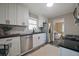 Modern kitchen with stainless steel appliances, white cabinets, black hardware and tile backsplash at 5636 Crittenden Ave, Indianapolis, IN 46220