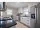 Bright kitchen with stainless steel refrigerator and appliances and a window above the sink at 5636 Crittenden Ave, Indianapolis, IN 46220