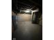 Unfinished basement featuring painted walls, hot water tank, and exposed ceiling fixtures at 5704 N Keystone Ave, Indianapolis, IN 46220