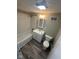Bathroom features a tub-shower combination with wood-look flooring, a new vanity, and modern lighting at 5704 N Keystone Ave, Indianapolis, IN 46220