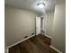 Cozy bedroom with modern flooring, neutral walls, and a view of the hallway at 5704 N Keystone Ave, Indianapolis, IN 46220