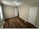 Spacious bedroom featuring wood-look flooring and neutral paint at 5704 N Keystone Ave, Indianapolis, IN 46220