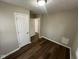 Bedroom with wood-look flooring, neutral paint, and ample closet space at 5704 N Keystone Ave, Indianapolis, IN 46220