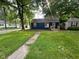 Charming single-story home with a well-maintained lawn and inviting front porch at 5704 N Keystone Ave, Indianapolis, IN 46220