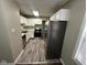Bright kitchen with white cabinetry, stainless steel appliances, and modern flooring at 5704 N Keystone Ave, Indianapolis, IN 46220
