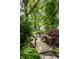 Charming backyard with a wooden bridge and mature landscaping at 5919 Central Ave, Indianapolis, IN 46220