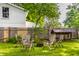 Backyard featuring a fire pit, patio seating area, wooden fence, and lush green grass at 5919 Central Ave, Indianapolis, IN 46220