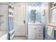 Bright bathroom with tiled shower, white vanity, and classic fixtures at 5919 Central Ave, Indianapolis, IN 46220
