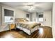 Cozy bedroom with hardwood floors, ceiling fan, and natural light at 5919 Central Ave, Indianapolis, IN 46220