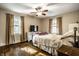 Comfortable bedroom with hardwood floors, neutral decor, and natural light at 5919 Central Ave, Indianapolis, IN 46220