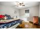 Inviting bedroom with warm decor, hardwood floors, and a ceiling fan at 5919 Central Ave, Indianapolis, IN 46220
