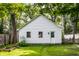 A detached garage featuring two windows, a single door, and lush green grass at 5919 Central Ave, Indianapolis, IN 46220