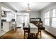 Elegant dining room with hardwood floors, vintage light fixture, and adjacent living area at 5919 Central Ave, Indianapolis, IN 46220