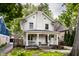 Charming two-story home featuring a covered front porch and well-maintained landscaping at 5919 Central Ave, Indianapolis, IN 46220