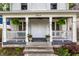 Inviting front porch with swing, lush ferns, and classic architectural details at 5919 Central Ave, Indianapolis, IN 46220
