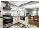 Open kitchen layout with stainless steel appliances and a view into the dining area at 5919 Central Ave, Indianapolis, IN 46220