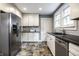 Spacious kitchen featuring stainless steel refrigerator and plenty of cabinet space at 5919 Central Ave, Indianapolis, IN 46220