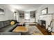 Living room featuring a fireplace, built-in bookshelves, and comfortable grey sofa at 5919 Central Ave, Indianapolis, IN 46220