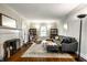 Cozy living room with a fireplace, comfortable seating, and hardwood floors with area rug at 5919 Central Ave, Indianapolis, IN 46220