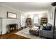 Inviting living room featuring a fireplace, comfortable seating, and built-in bookshelves at 5919 Central Ave, Indianapolis, IN 46220