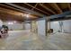 Open basement with exposed beams and utilities, offering possibilities for renovation at 5923 W 29Th Pl, Indianapolis, IN 46224