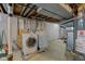Functional basement laundry area with washer, dryer, and utilities for added convenience at 5923 W 29Th Pl, Indianapolis, IN 46224
