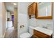 Full bathroom with vintage wooden cabinets and lighting at 5923 W 29Th Pl, Indianapolis, IN 46224