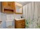 Bathroom featuring a wood vanity, a decorative mirror, and a nature-themed shower curtain at 5923 W 29Th Pl, Indianapolis, IN 46224