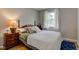 Comfortable bedroom featuring a wooden bed frame, soft pillows, and a cozy atmosphere at 5923 W 29Th Pl, Indianapolis, IN 46224
