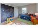 Cozy bedroom with a chalkboard wall, a colorful table, and a comfortable bed at 5923 W 29Th Pl, Indianapolis, IN 46224