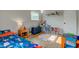 Bright bedroom featuring hardwood floors, playful decor, and a cozy atmosphere at 5923 W 29Th Pl, Indianapolis, IN 46224