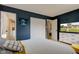 Large bedroom featuring a full sized bed, walk in closet, and television at 5923 W 29Th Pl, Indianapolis, IN 46224