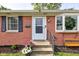 A welcoming front porch with potted flowers and a cozy bench seat at 5923 W 29Th Pl, Indianapolis, IN 46224
