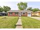 Charming red brick home with a well-manicured lawn and inviting front entrance at 5923 W 29Th Pl, Indianapolis, IN 46224