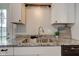 A close up of the kitchen sink, featuring custom granite countertops at 5923 W 29Th Pl, Indianapolis, IN 46224