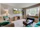 Bright living room with bay window, built-in bench, and hardwood floors at 5923 W 29Th Pl, Indianapolis, IN 46224