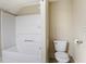 Bathroom featuring a white shower-tub combo, toilet, and neutral walls at 602 Prospect St, Indianapolis, IN 46203
