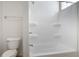 Bathroom featuring white fixtures including a toilet and a shower-tub combo at 602 Prospect St, Indianapolis, IN 46203
