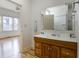 Bathroom with vanity, mirror, and doorway to an adjacent room at 602 Prospect St, Indianapolis, IN 46203