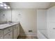 Bathroom featuring a white vanity, shower-tub combo with vinyl flooring at 602 Prospect St, Indianapolis, IN 46203