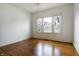 Bedroom with hardwood floors, trim, and ample natural light from three large windows at 602 Prospect St, Indianapolis, IN 46203