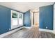 Bedroom featuring neutral paint, ample natural light, and laminate flooring at 602 Prospect St, Indianapolis, IN 46203