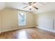Neutral bedroom with wood-look floors, a ceiling fan, and a window at 602 Prospect St, Indianapolis, IN 46203