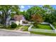 A charming home's lush landscaping, white picket fence, and inviting curb appeal at 602 Prospect St, Indianapolis, IN 46203