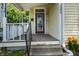 Welcoming front porch with steps and railing leading to the front door, enhanced by colorful flower plantings at 602 Prospect St, Indianapolis, IN 46203