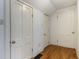 Hallway featuring three white doors, light blue walls, and wood-look vinyl flooring at 602 Prospect St, Indianapolis, IN 46203