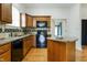 A well-equipped kitchen featuring granite counters, custom cabinets, and stainless steel appliances at 602 Prospect St, Indianapolis, IN 46203