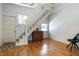 Bright living room featuring hardwood floors, staircase, and natural light at 602 Prospect St, Indianapolis, IN 46203